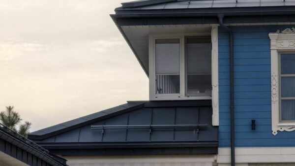 A stylish blue house featuring unique geometric windows, showcasing modern architecture.