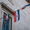 Flags of Croatia on a historic building facade, perfect for cultural and architectural themes.