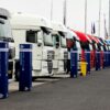 Line of racing trucks with bollards at event in Estoril, Portugal.