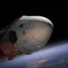 A SpaceX Dragon spacecraft orbiting Earth, captured in vivid detail against space.