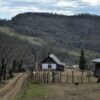 Tranquil rural village with wooden houses in a mountain landscape.