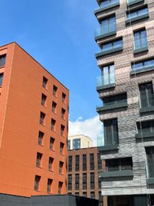 Contemporary residential buildings in Moscow under a clear blue sky.