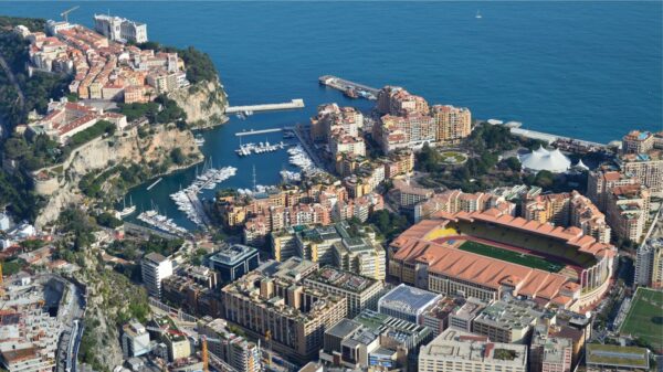 Scenic aerial view of Monaco's coastal cityscape with harbors and Mediterranean Sea.