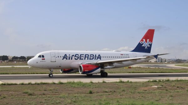 Air Serbia Airbus A320 on the runway ready for takeoff on a clear day.