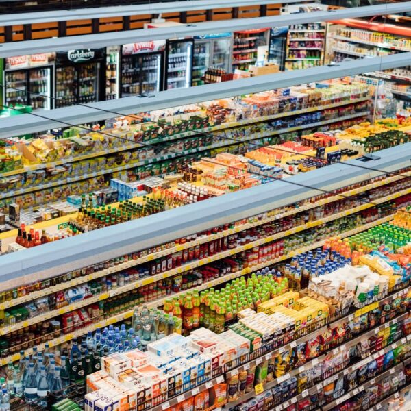 Explore the colorful, fully-stocked shelves of a bustling supermarket from above.