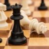 Close-up of chess pieces on a board depicting strategy and challenge.