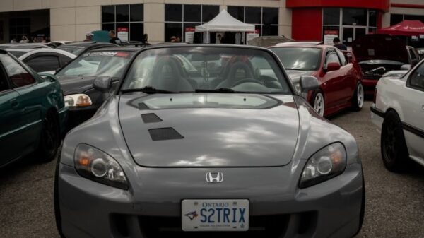 Honda dealership showcasing a sleek parked car on a cloudy day.