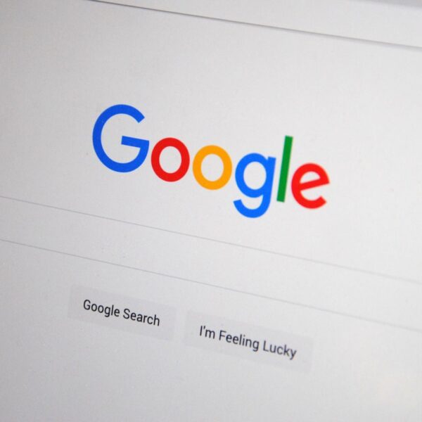 Close-up of the Google homepage on a screen showing search options.