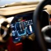 Close-up of illuminated car dashboard interior showing digital displays in Dubai showroom.