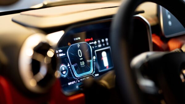 Close-up of illuminated car dashboard interior showing digital displays in Dubai showroom.