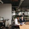 Diverse team engaged in a meeting in a modern open office environment.