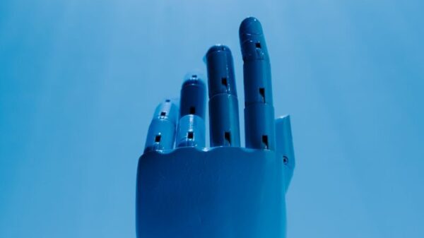 A robotic hand reaching out against a radiant blue sky, symbolizing futuristic technology.