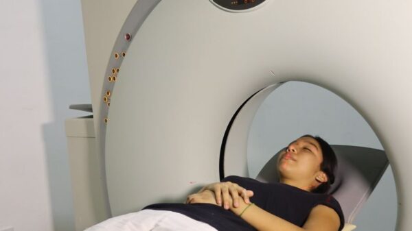 A woman lying inside an MRI machine during a medical procedure in a hospital setting.