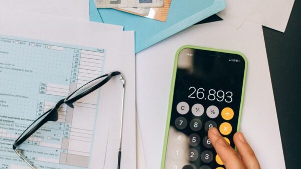 A top view of financial documents, calculator on smartphone, and euro notes, depicting business analysis.