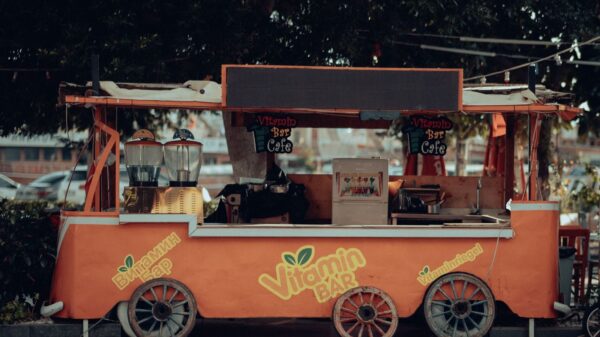 An inviting orange juice bar cart, perfect for urban street vibes.