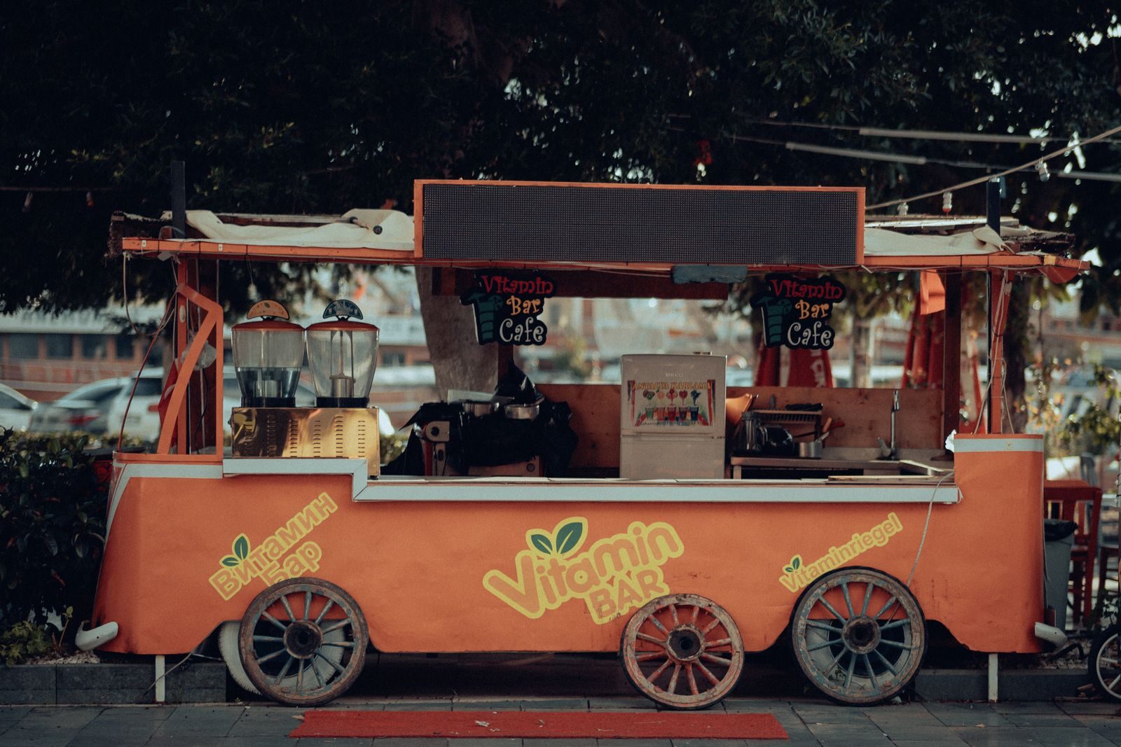 An inviting orange juice bar cart, perfect for urban street vibes.