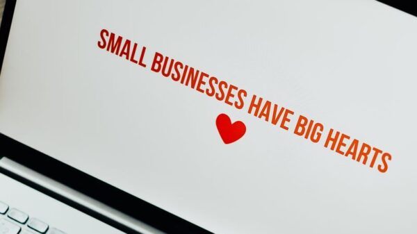 Close-up of laptop displaying 'Small Businesses Have Big Hearts' message with a heart icon.