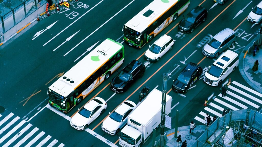 Aerial photograph capturing a busy city intersection filled with buses and cars, showcasing urban traffic.
