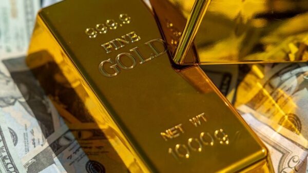 Close-up of gold bars atop US currency, symbolizing wealth and investment.