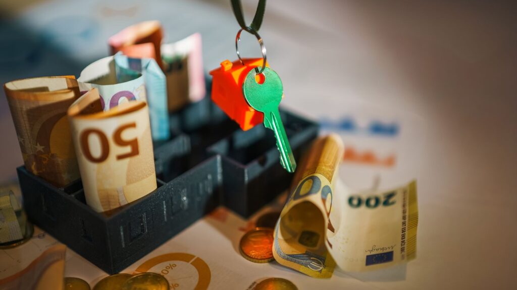 House key and euro bills depicting real estate and financial themes.