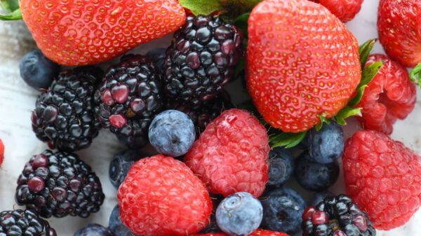 A vibrant close-up of fresh strawberries, raspberries, blackberries, and blueberries.