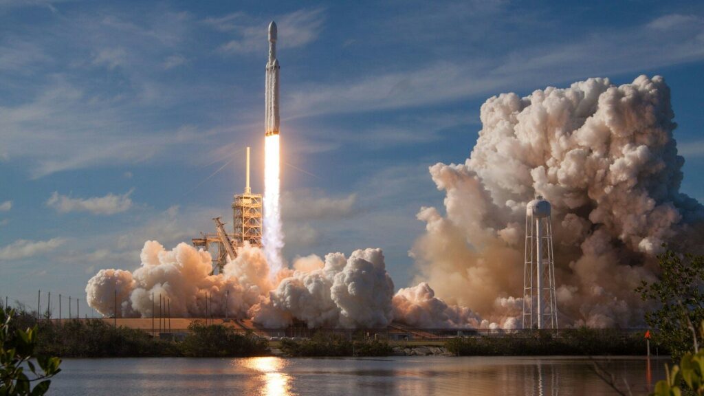 gray spacecraft taking off during daytime