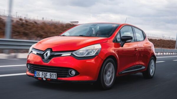 Dynamic shot of a red Renault Clio driving on a highway in Ankara, Türkiye.