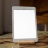 A contemporary tablet stands vertically on a marble table, perfect for mockup use.