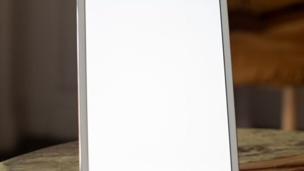 A contemporary tablet stands vertically on a marble table, perfect for mockup use.