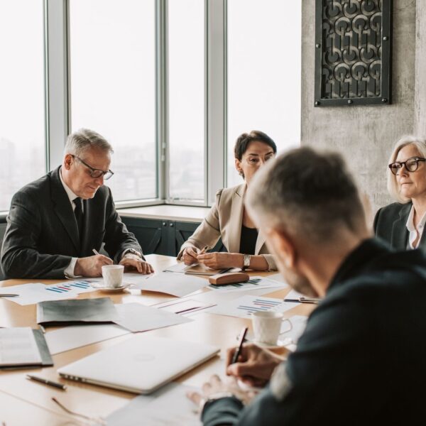Business professionals engaged in a collaborative meeting around a conference table.
