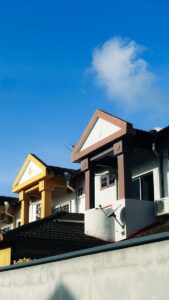 Vibrantly colored urban buildings under clear blue sky, highlighting architectural styles.
