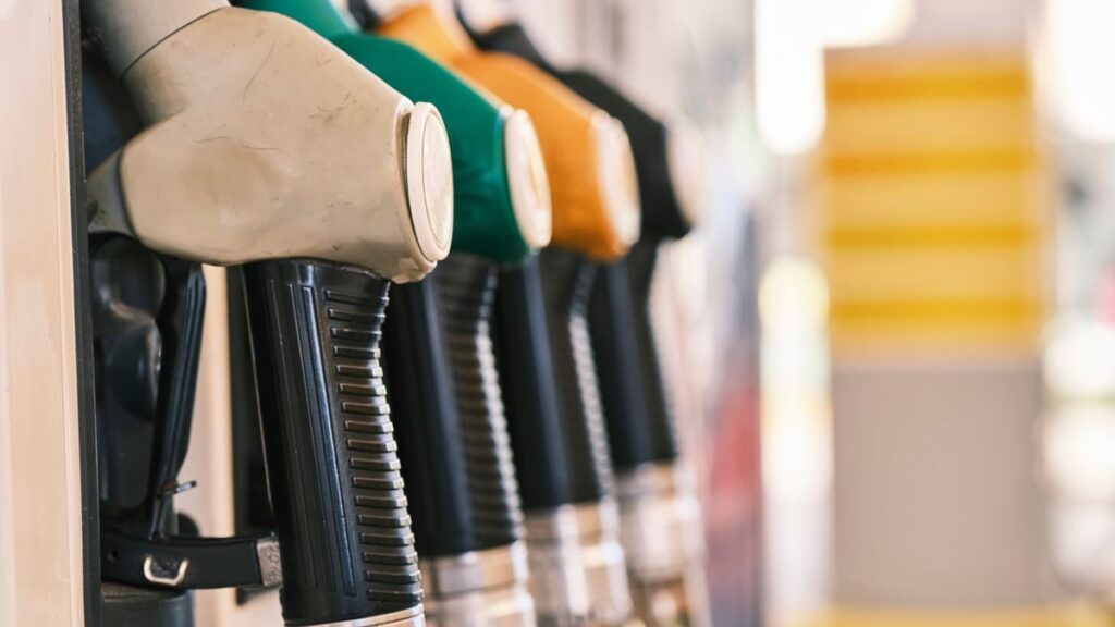 Close-up shot of colorful gas pump nozzles at a fuel station, emphasizing variety and choice.