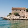 Beautiful stone house by the sea in summer, Croatia's stunning coastline.