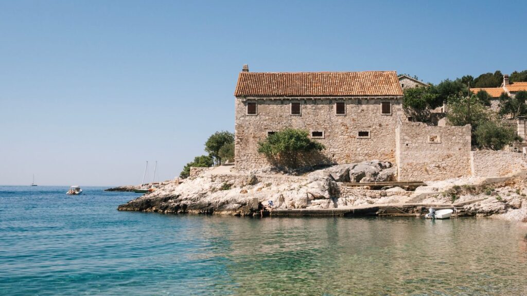 Beautiful stone house by the sea in summer, Croatia's stunning coastline.