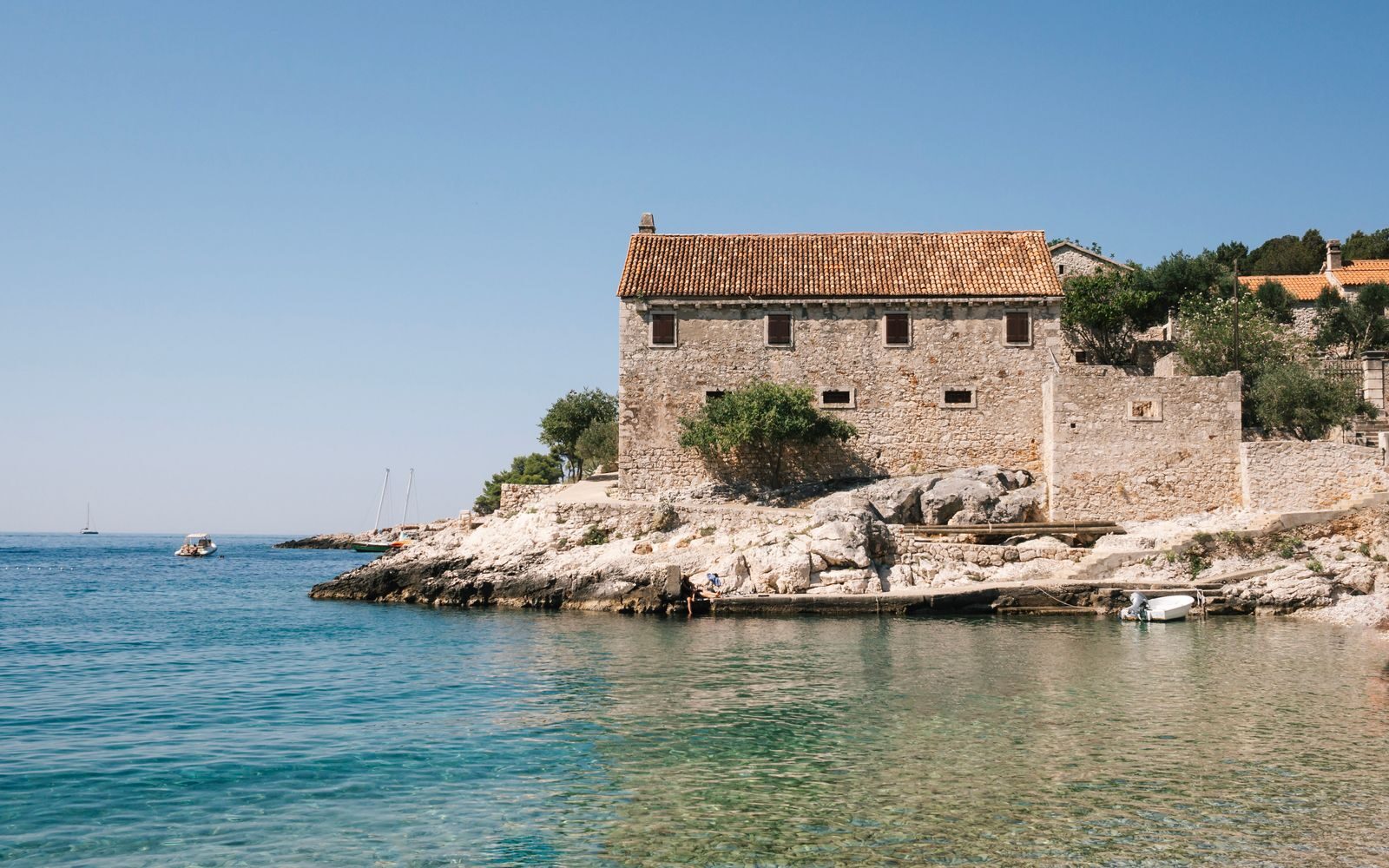 Beautiful stone house by the sea in summer, Croatia's stunning coastline.
