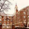 Historic brick building under a snowy sky with winter architecture charm.
