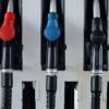 Close-up of multicolored fuel pumps at a gas station, showcasing different types of fuel.