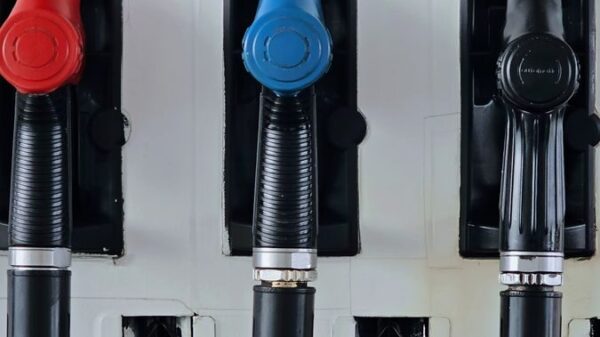 Close-up of multicolored fuel pumps at a gas station, showcasing different types of fuel.