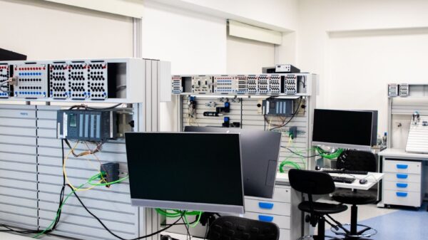 A contemporary computer lab with advanced workstations and electronic equipment, perfect for research and development.