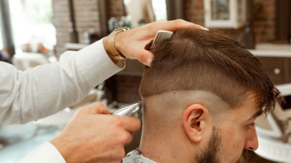 man in white dress shirt cutting hair of man