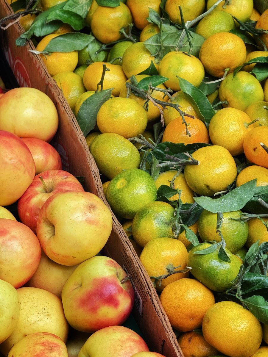 Vibrant display of fresh apples and citrus fruits at a market stall in Berlin, Germany.