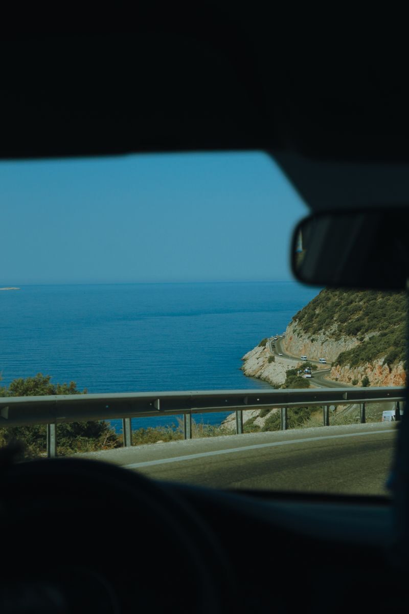 Enjoy a serene coastal road drive in Muğla, Türkiye with expansive ocean views.