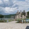 Scenic view of Golubac Fortress with tourists exploring the historic site in Serbia.