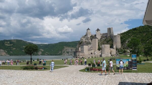 Scenic view of Golubac Fortress with tourists exploring the historic site in Serbia.