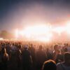A lively music festival in Budapest with a large crowd enjoying bright stage lights at night.