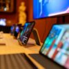 Close-up of modern tablets displayed on a wooden table in an electronics store.