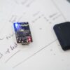 Close-up of a microprocessor and circuit board placed on technical design sketches.