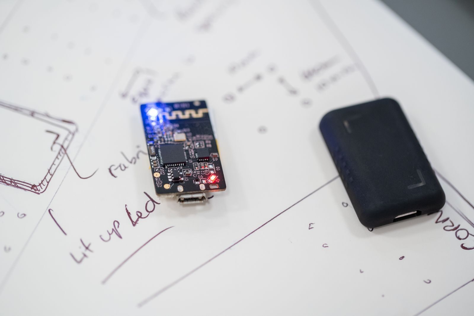 Close-up of a microprocessor and circuit board placed on technical design sketches.