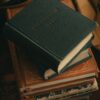 A vertical shot of a stack of vintage books with leather covers, perfect for literary themes.
