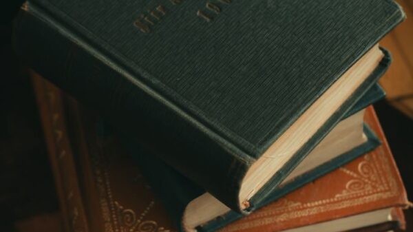 A vertical shot of a stack of vintage books with leather covers, perfect for literary themes.